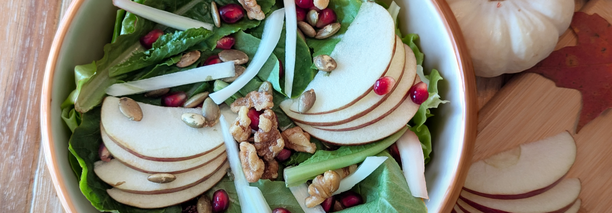 Fall Harvest Salad with Revolution Farms lettuce, apple slices, walnuts, and other ingredients.